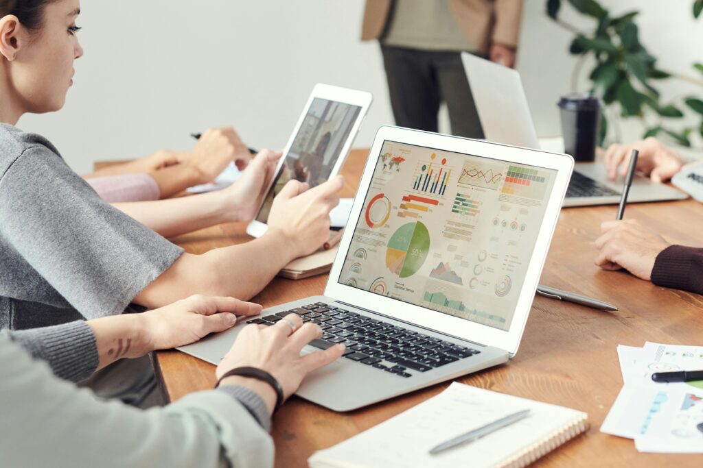Small business owner reviewing AI-powered data analytics on a laptop