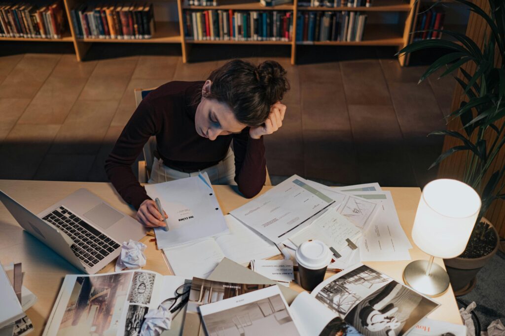 Stressed small business owner buried in work at their desk