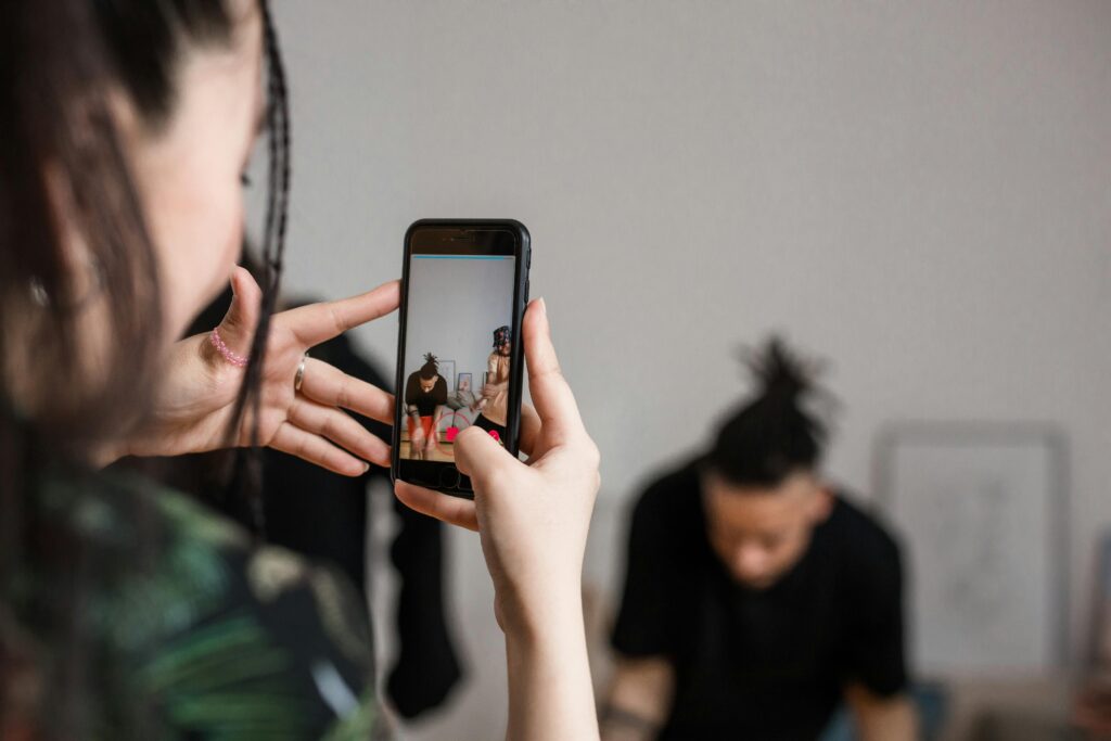A person recording a man on their phone to join the 2016 nostalgia trend
