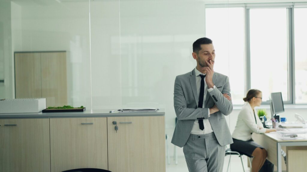 Small business owner in a suit thinking carefully about their next decision