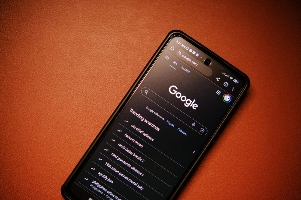 A phone showing the Google search page and trending topics