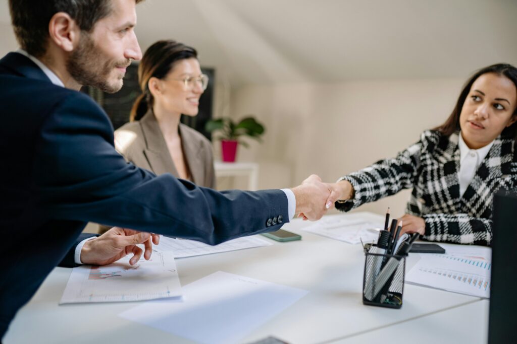 People shaking hands in an office setting
