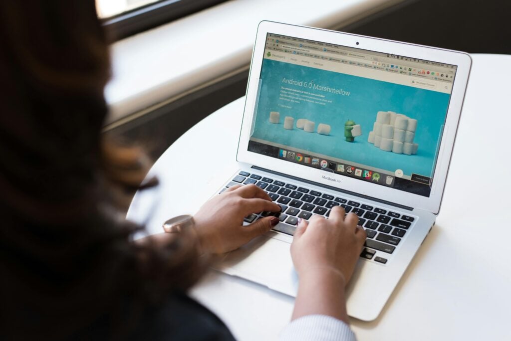 A person on their laptop with their small business website shown on the screen